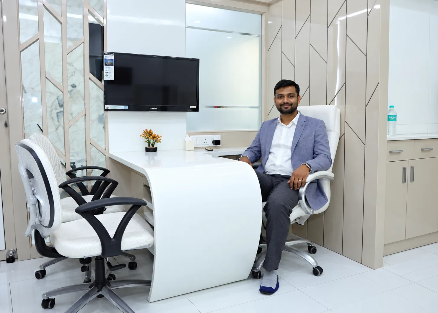Dr. Girish Bhangale in the consultation cabin at I DENT Dental Clinic, Wakad