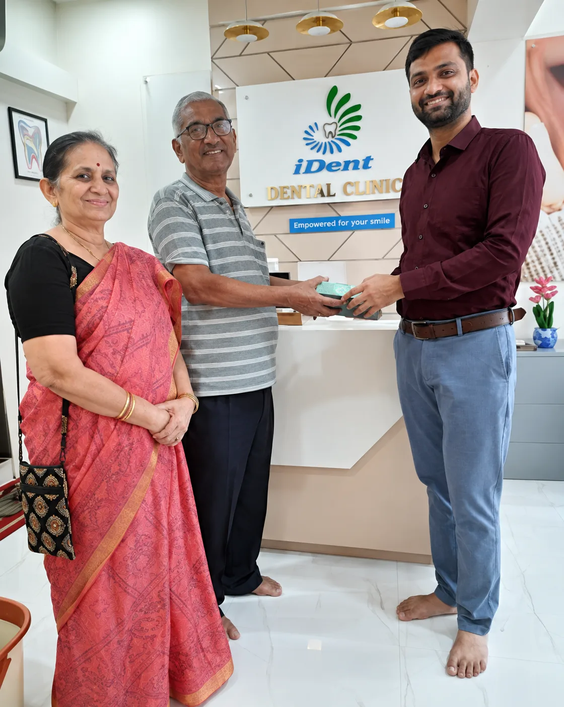 Happy patients with the doctor at I DENT Dental Clinic reception
